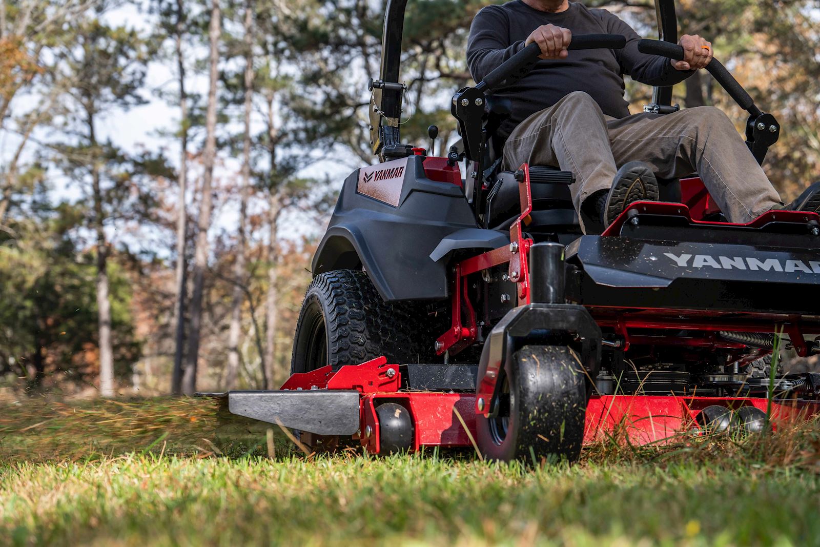 closeup of man mowing in a timber
