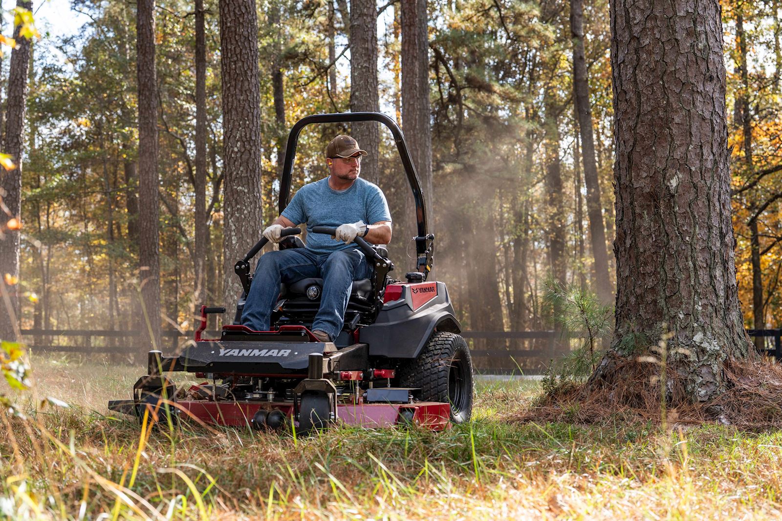 man mowering near a timber