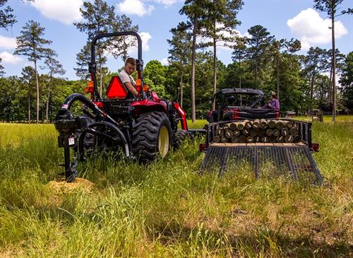 yanmar post hole digger in action on grass land
