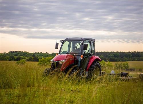 yanmar yt347 cab loader compact tractor driving through grass