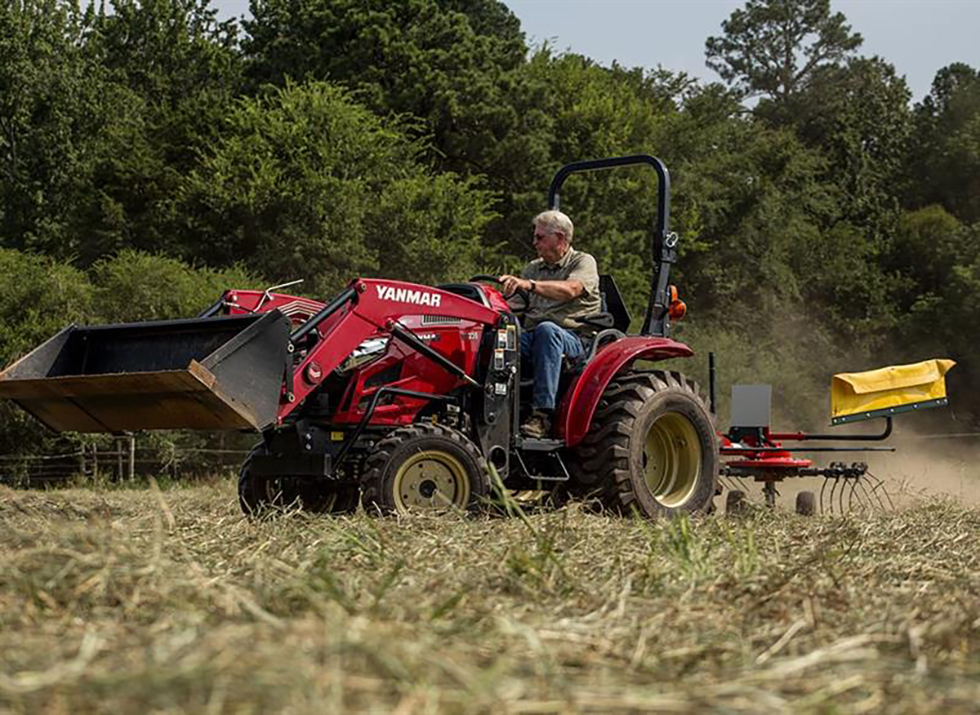 side image of yanmar tedder rake driving on land