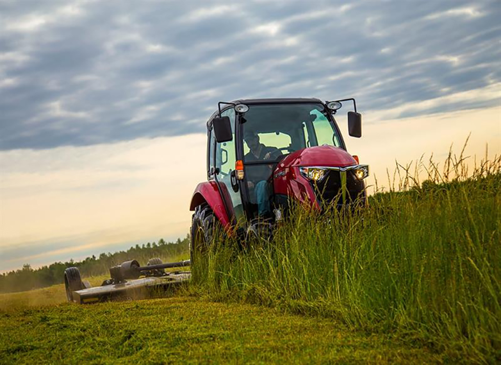 yanmar yt347 cab loader compact tractor driving through grass