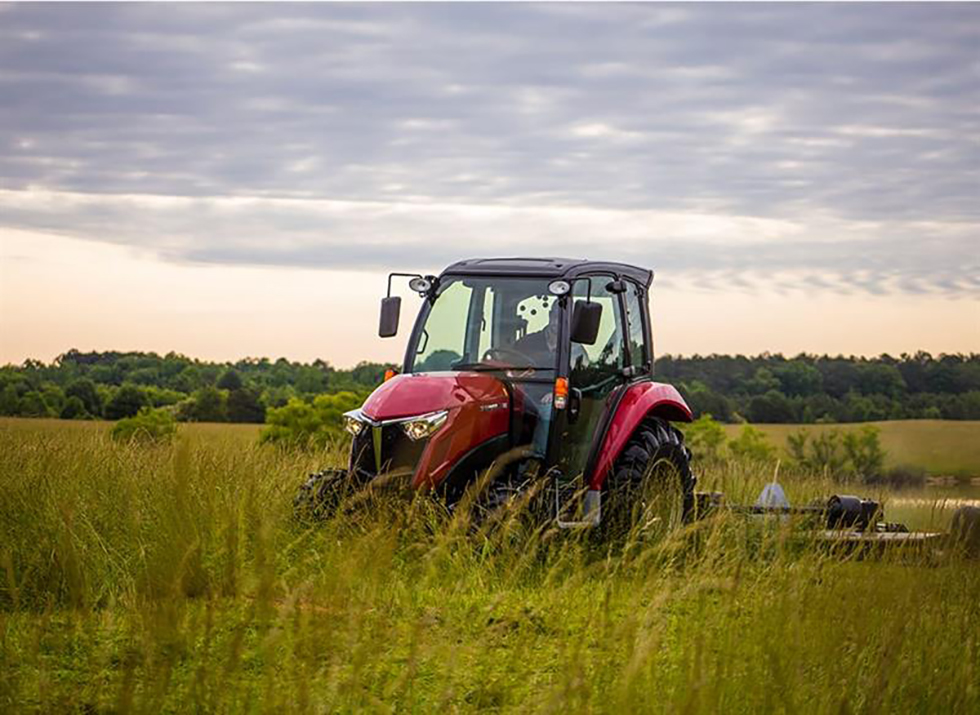 yanmar yt347 cab loader compact tractor driving through grass