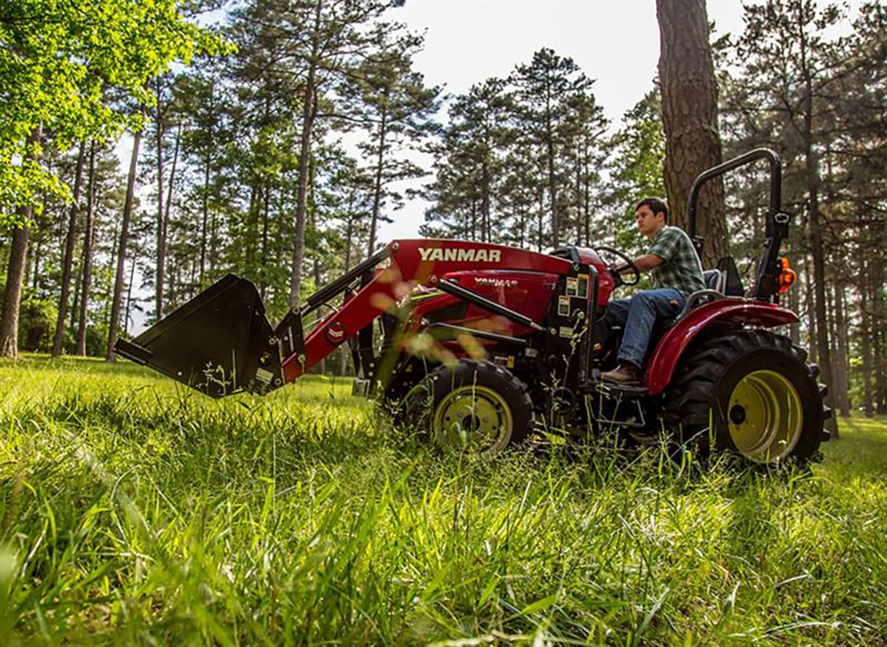 man driving on red yanmar compact tractor