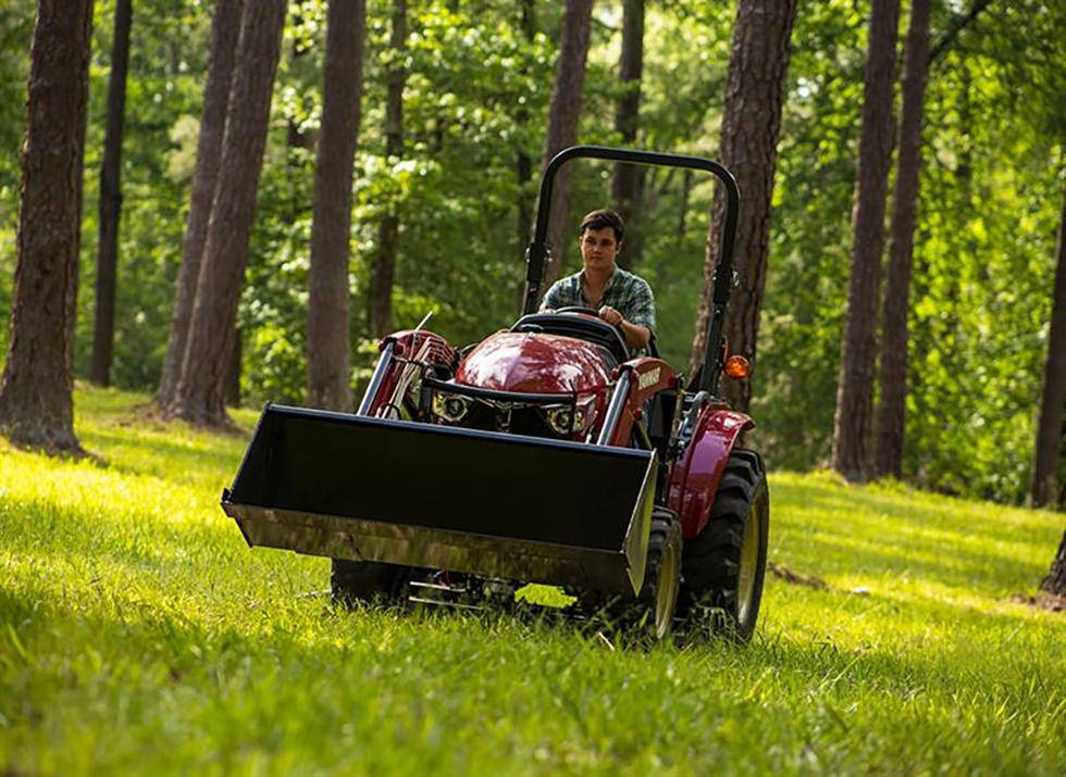 man driving on red yanmar compact tractor