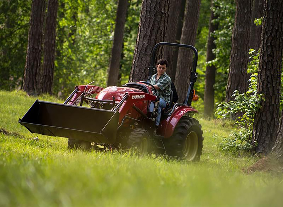 man driving on red yanmar compact tractor